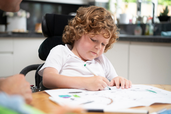 Child drawing at kitchen table